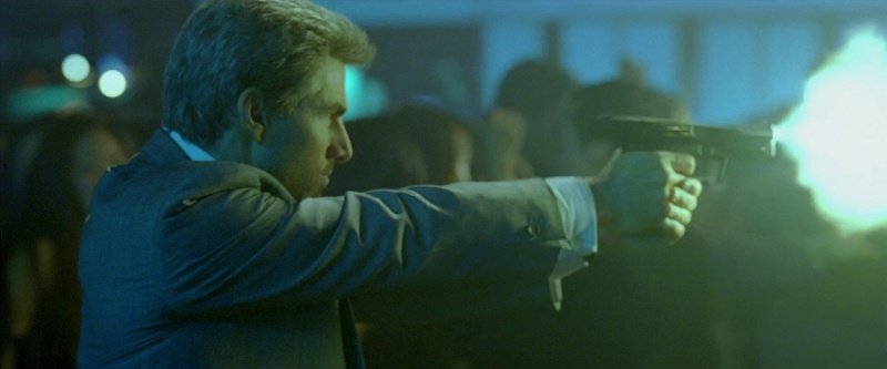 Tom Cruise, as Vincent, confidently fires the USP
