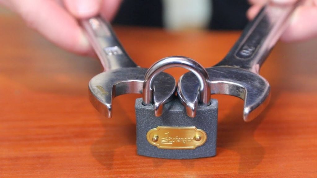 breaking padlock with wrenches